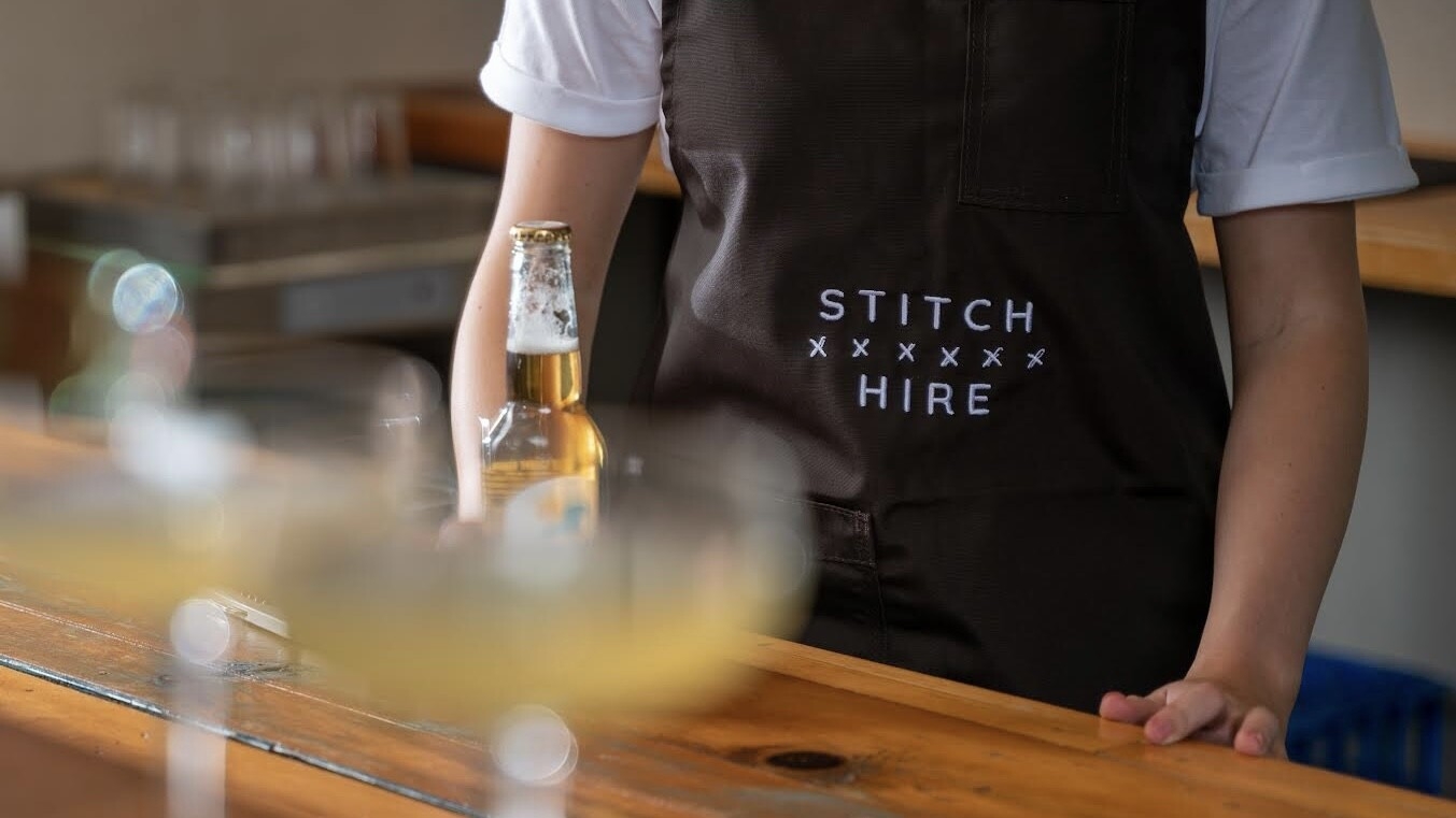 Stitch Hire worker serving a beer